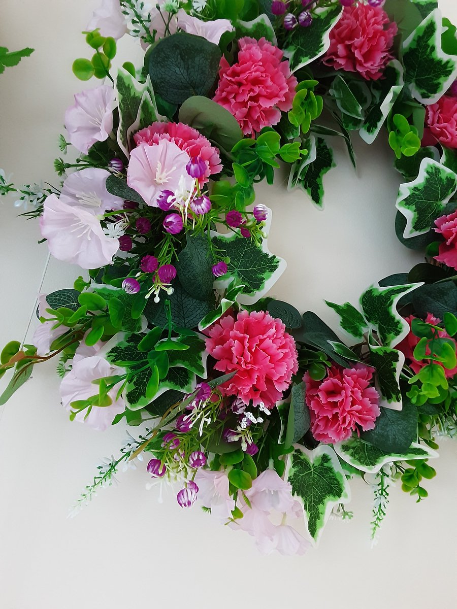 Diana. 40cm wreath, assorted pink flowers and green and white foliage. 
