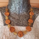 Orange, gold and brown disc shaped polymer clay necklace