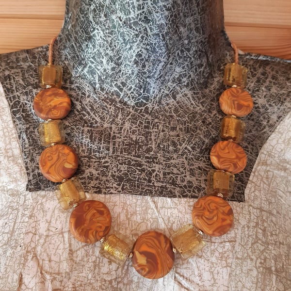 Orange, gold and brown disc shaped polymer clay necklace