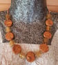 Orange, gold and brown disc shaped polymer clay necklace