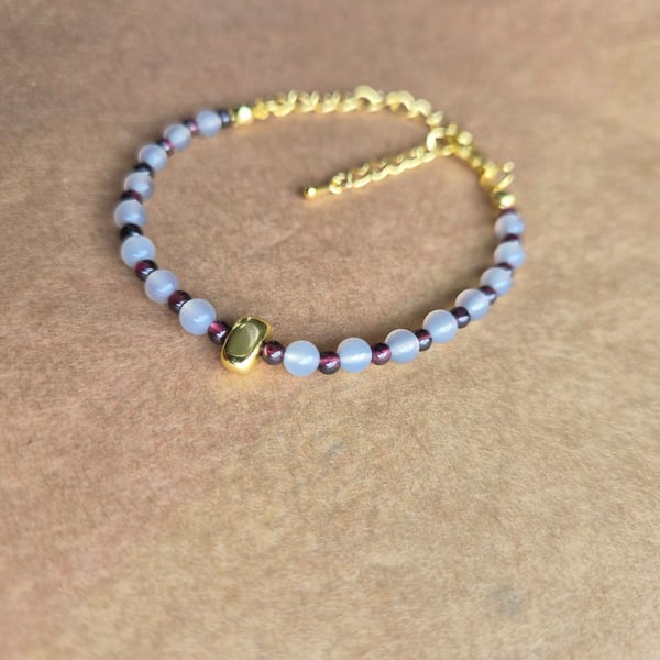 Owl grey and deep red, Strength stone gold bracelet.