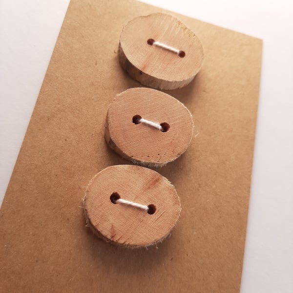 Three flat driftwood buttons