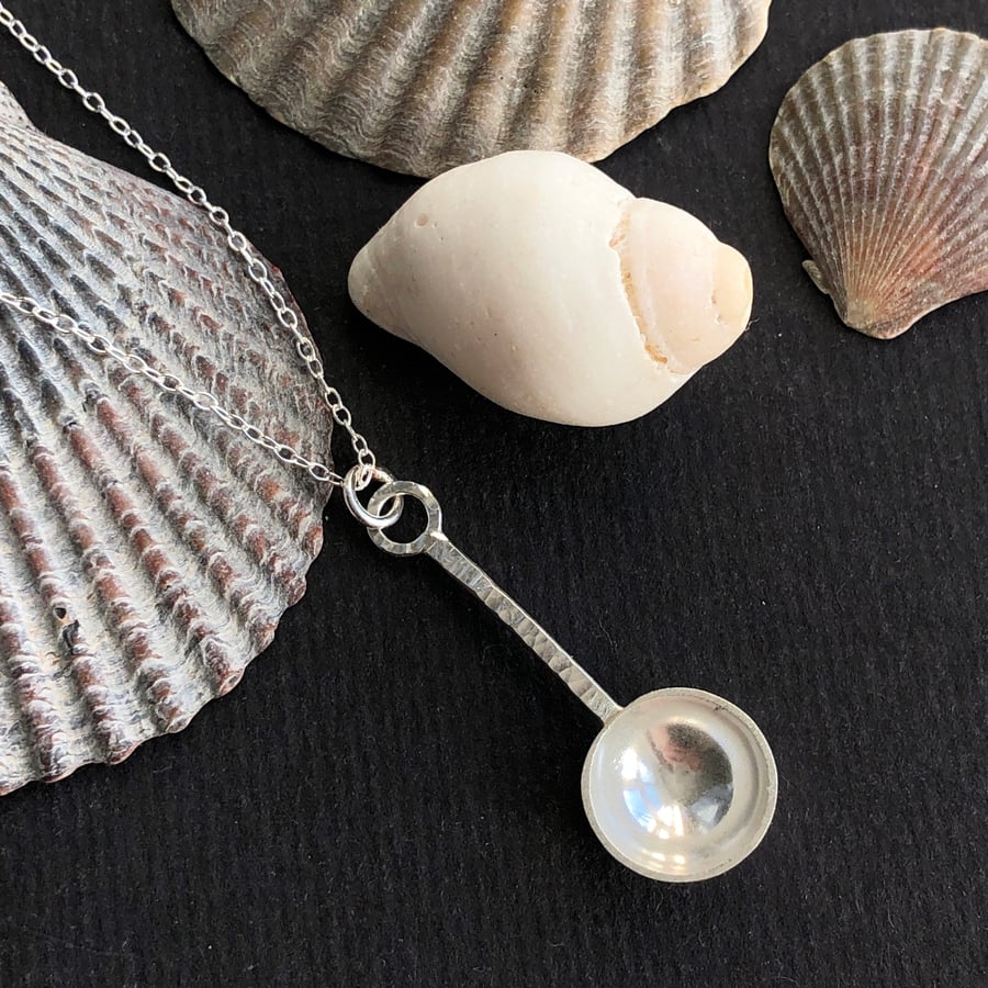 Sterling silver spoon pendant with hammered detail.
