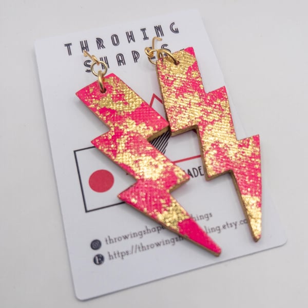 Handmade Neon pink lightening bolt earrings made from leather. Gold leaf details