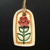 Small yellow ceramic tag decoration with flower button