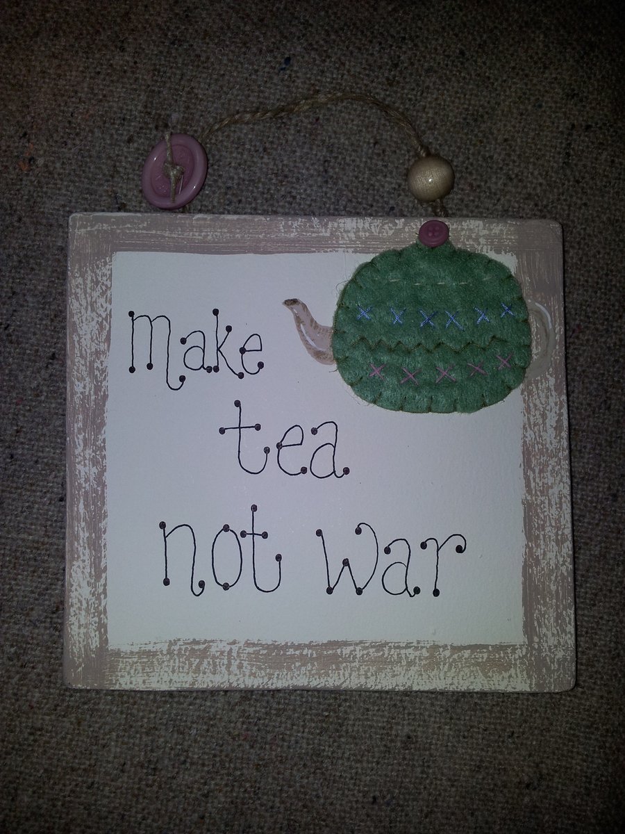 'Make Tea not War' wooden wall plaque.