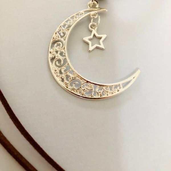 Crescent moon and star pendant on necklace