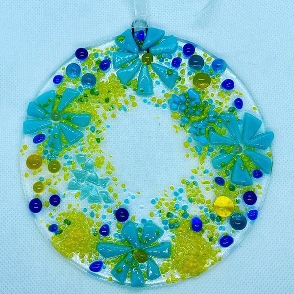 Fused glass hanging decoration in blues and yellows