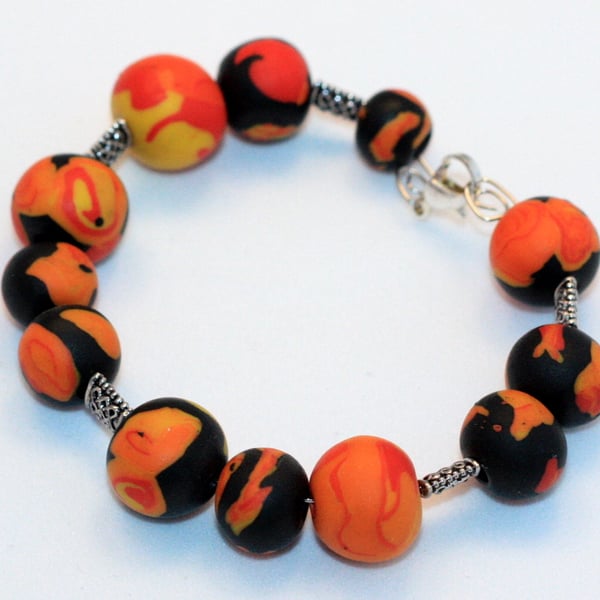 Polymer clay bracelet in black, orange, red and yellow