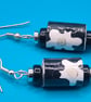 Black paper beaded earrings with white flower patterns - Image 1