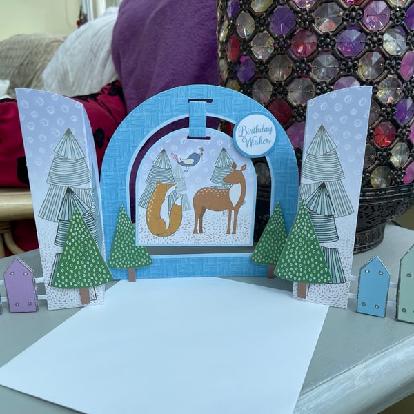 A unique and quirky fox and deer hanging picture card