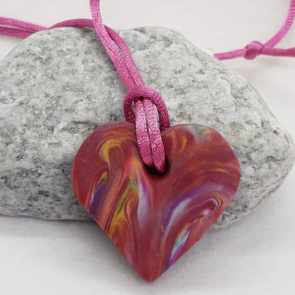 Heart shaped polymer clay pendant in shades of pink