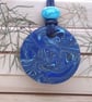 Round blue polymer clay pendant