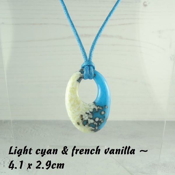 Handcrafted fused glass off-set oval pendant on a waxed cotton cord