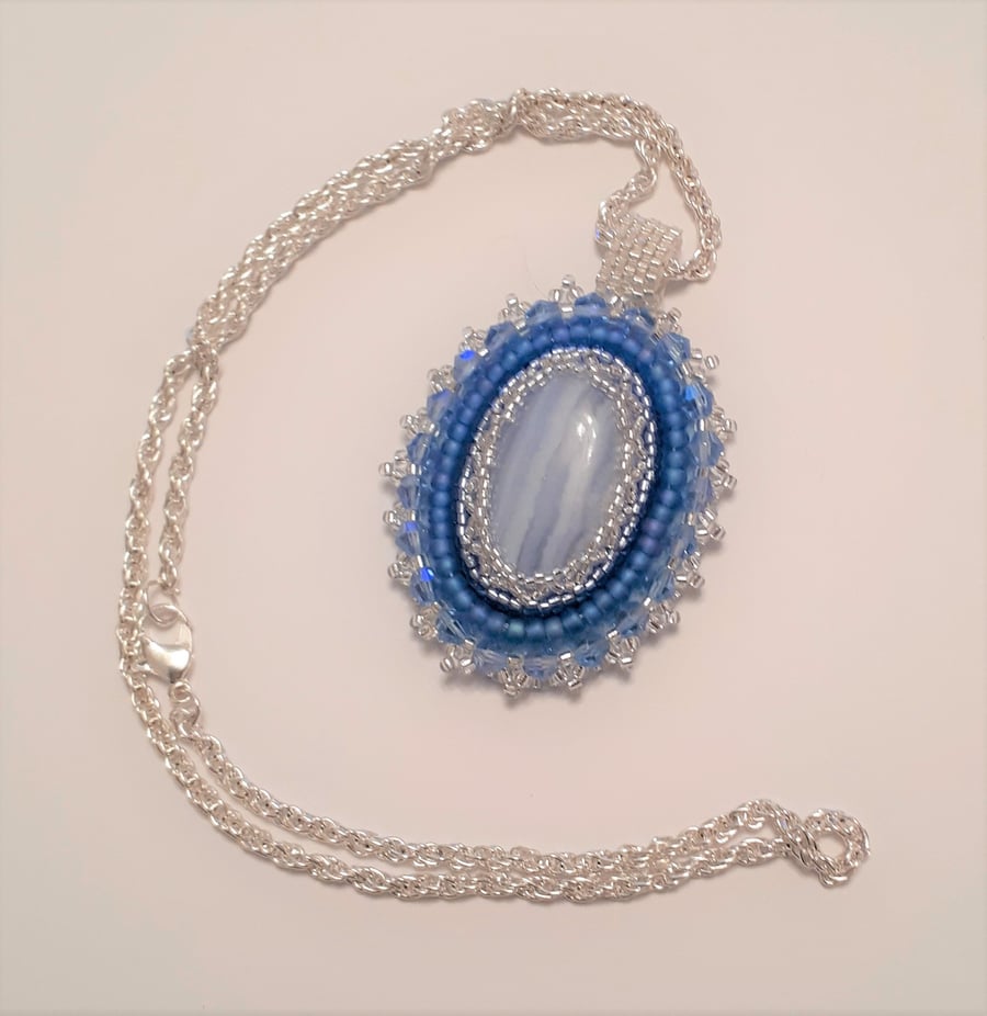 Blue Lace Agate bead embroidered pendant on a silver tone chain   