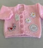 Baby girl cardigan with attachments