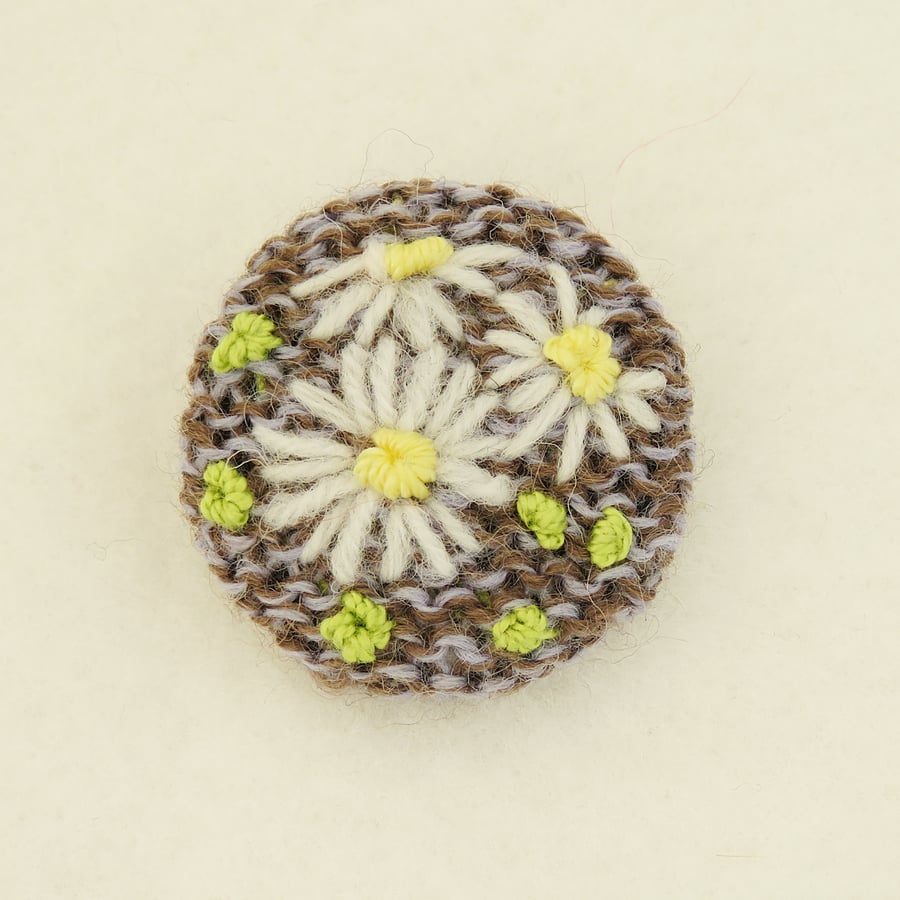 Daisy Brooch embroidered on knitted grey and beige background