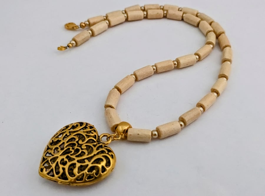 Cream wooden bead necklace with gold puffed heart pendant 1002723