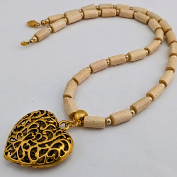 Cream wooden bead necklace with gold puffed heart pendant 1002723