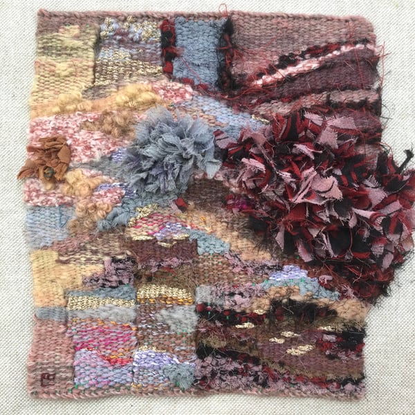 Unframed handwoven tapestry weaving, in pink, grey, peach, red and black