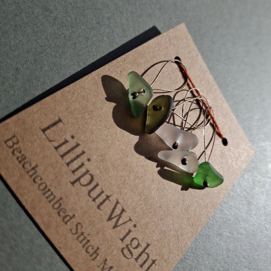 Five white and green snagfree sea glass stitch markers