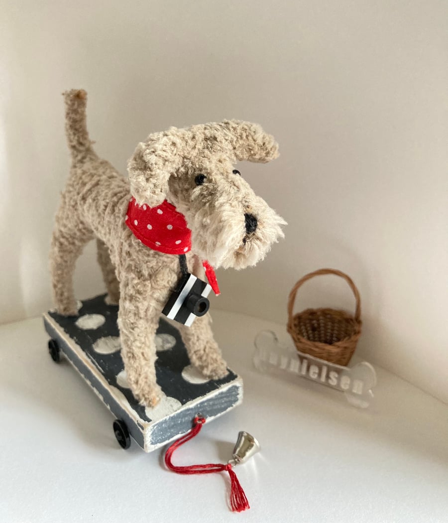 Scruffy Dog on a Wooden Trolley with Wheels 