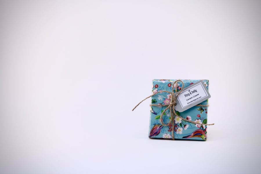 A Set of Four 10 by 10 cm High Gloss Ceramic Tile Coasters .