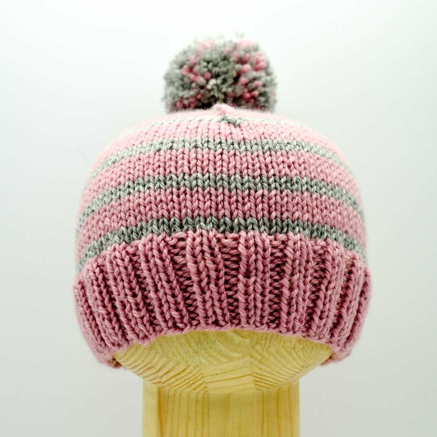 Hand knitted baby hat in pink and grey stripes