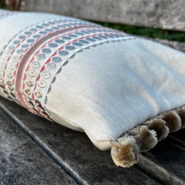Long embroidered linen cushion cover with pompoms