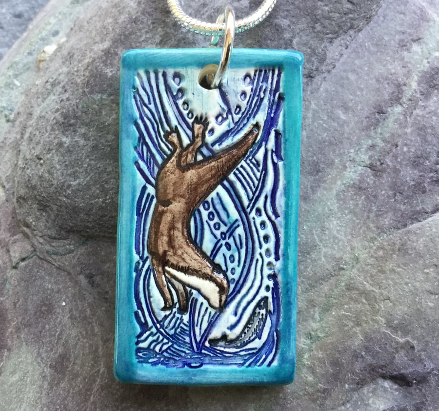 Image of Handmade Ceramic Otter pendant in turquoise blue