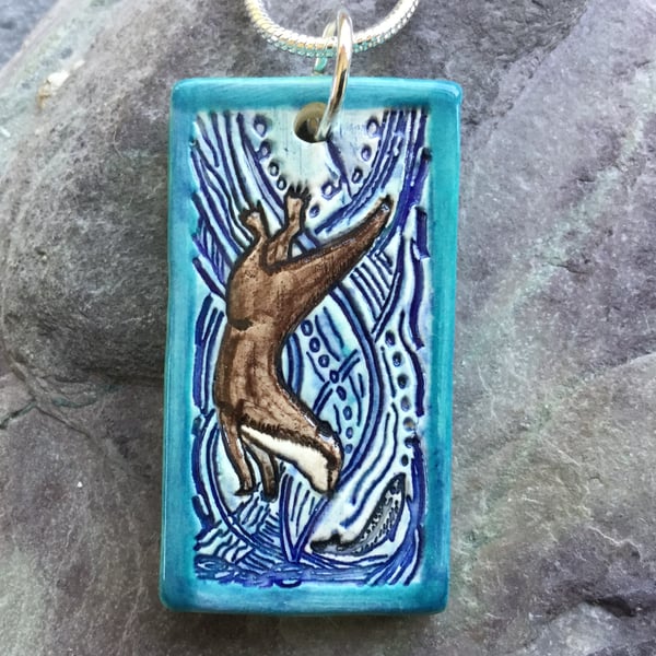 Handmade Ceramic Otter pendant in turquoise blue