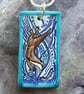 Handmade Ceramic Otter pendant in turquoise blue - Image 1