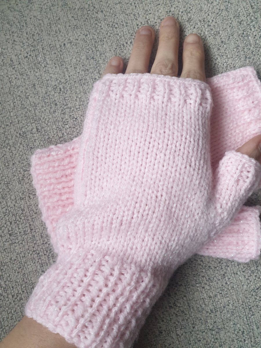 Pink knitted fingerless gloves.