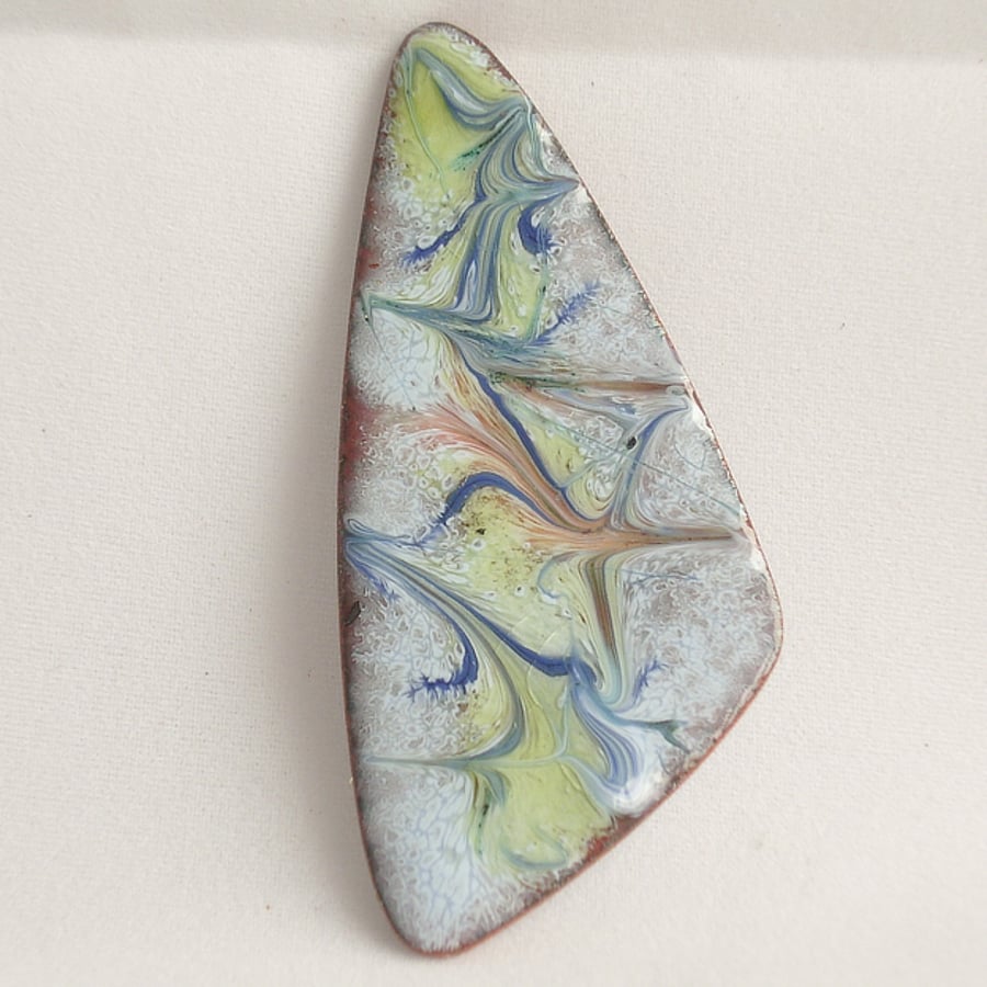 brooch: triangular - scrolled blue, orange, yellow, on pale blue over clear