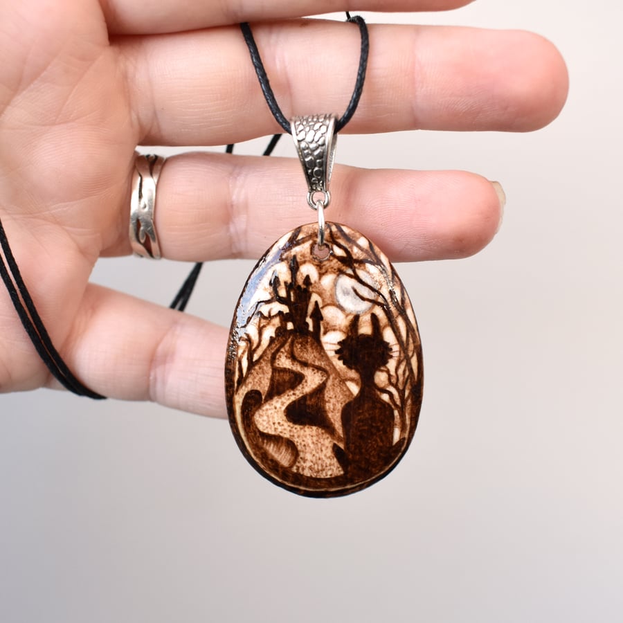 The spooky cat. Pyrography wood pendant of cat and castle