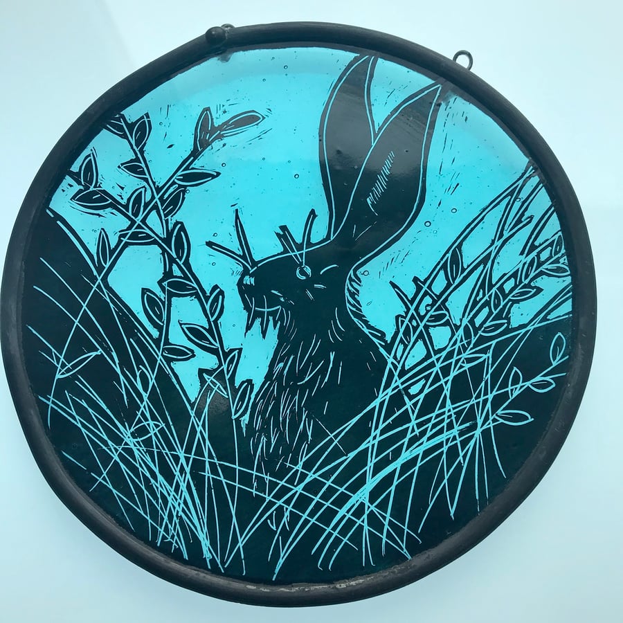 stained glass panel of a hare, blue, circle, wildlife art