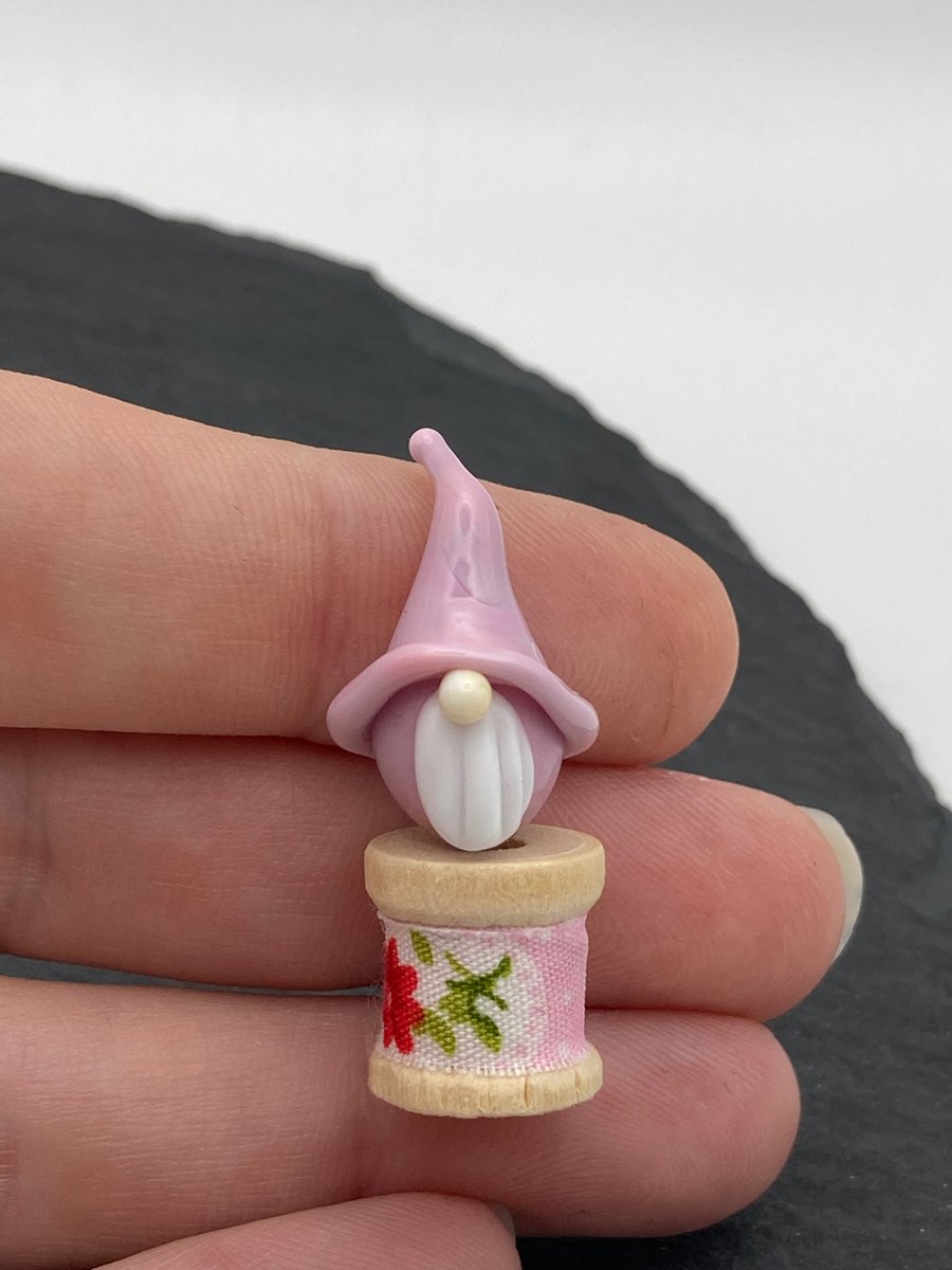 small gnome on a wooden bobbin