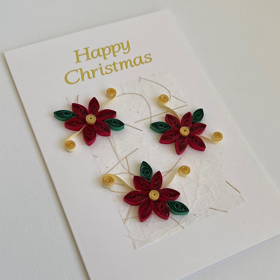 Handmade Christmas card with quilled poinsettias