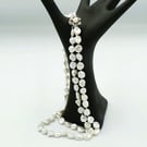 Natural pearl necklace with a silver crystal clasp  Traditionally knotted silk
