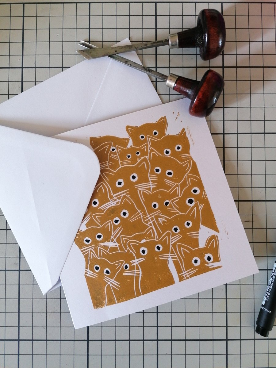 "lots of cats with big eyes", handprinted Linocut greeting card. Blank. Ochre.
