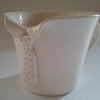 Individual hand-thrown ceramic pottery mug or cup with tie detail.