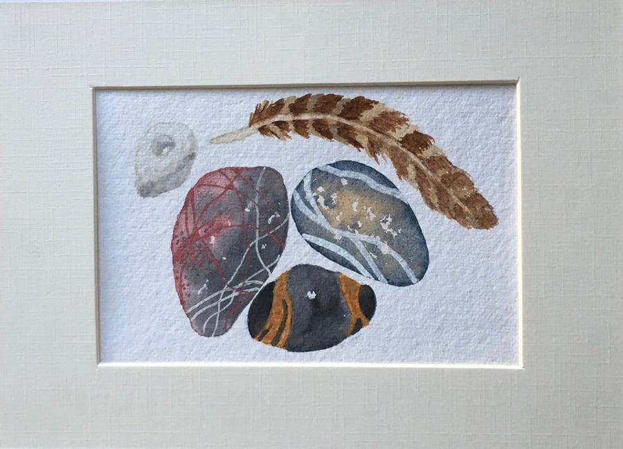 Chalk hagstone and feather artwork 