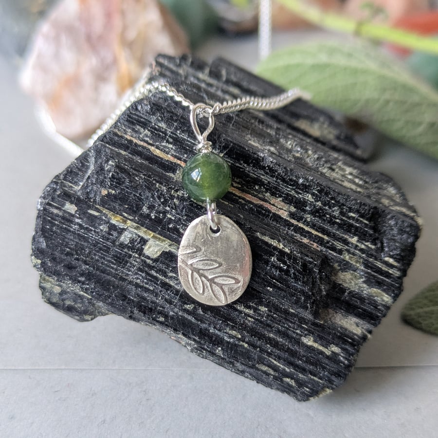 Abundance bringing oval silver pendant with green moss agate