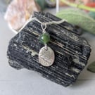Abundance bringing oval silver pendant with green moss agate