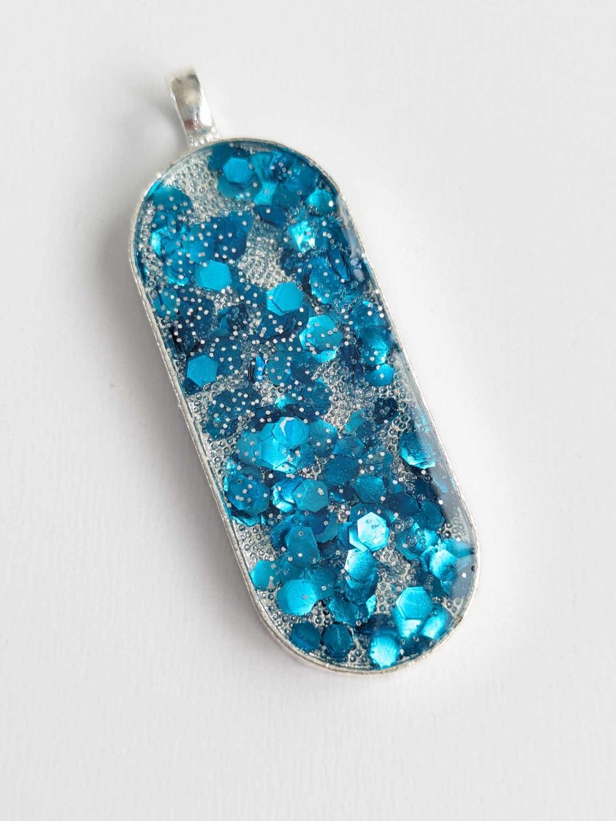 Long Oval Pendant With Blue Chunky Glitter