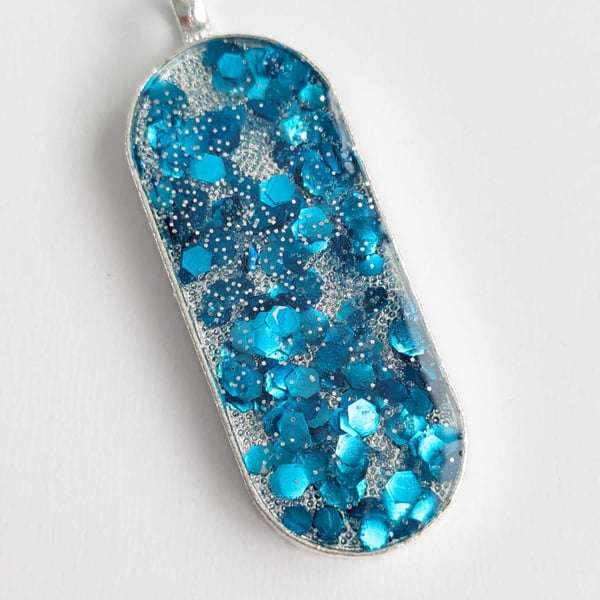 Long Oval Pendant With Blue Chunky Glitter