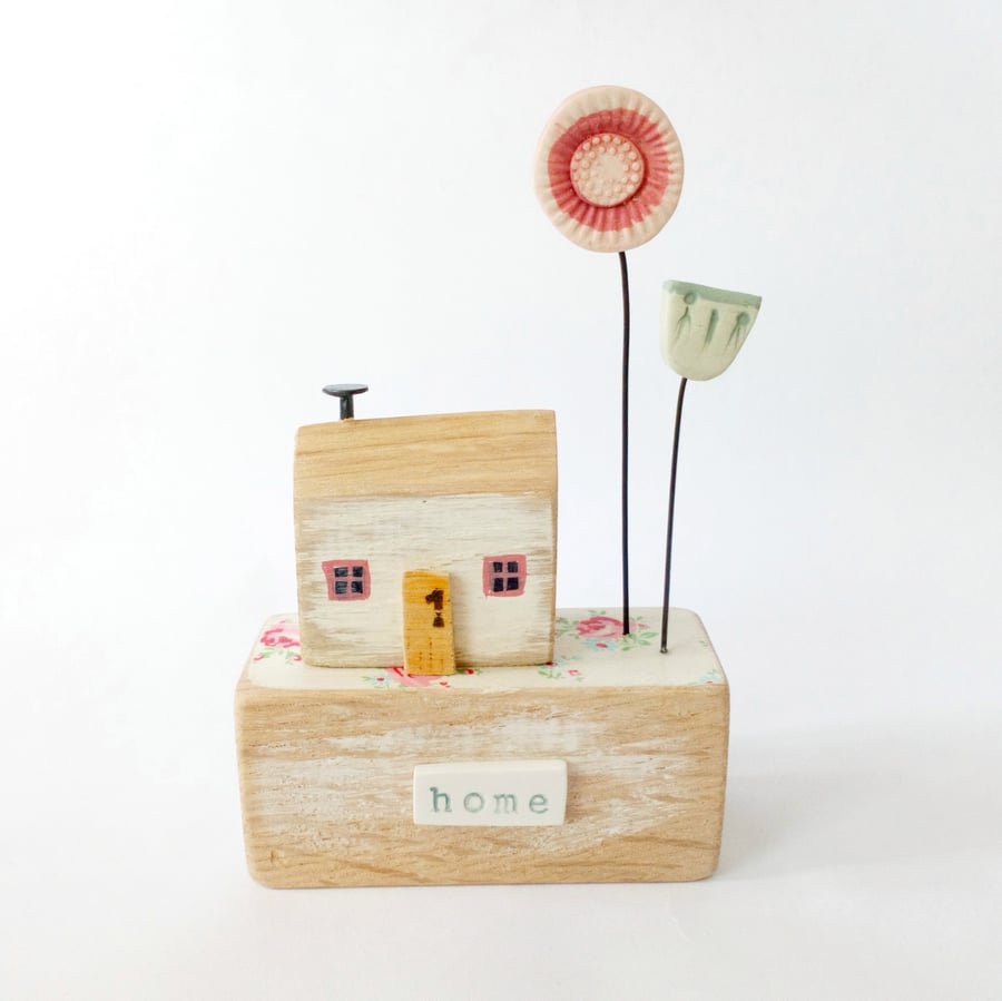 Wooden house with clay flower garden 'home'