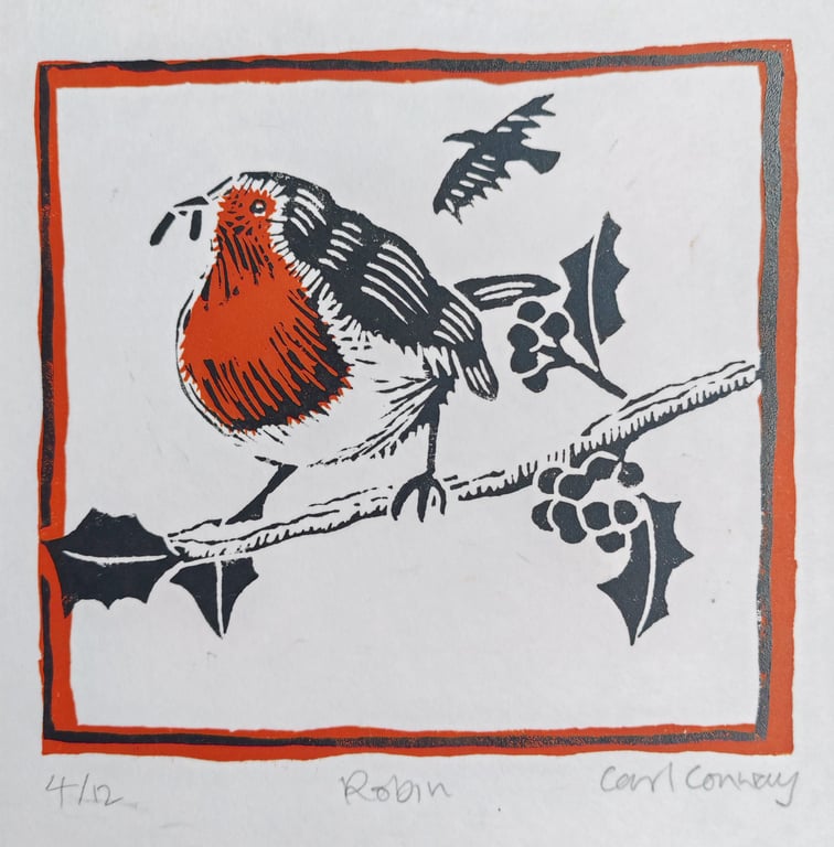 Robin on a holly branch
