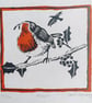 Robin on a holly branch