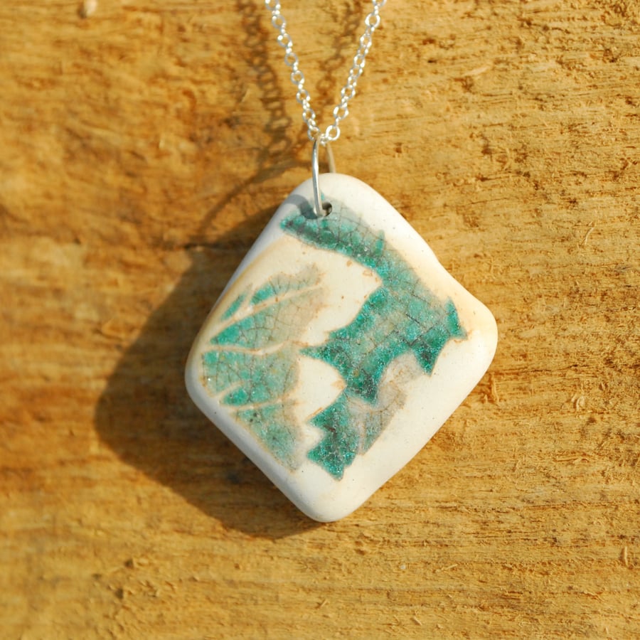 Beach pottery pendant with green leaves